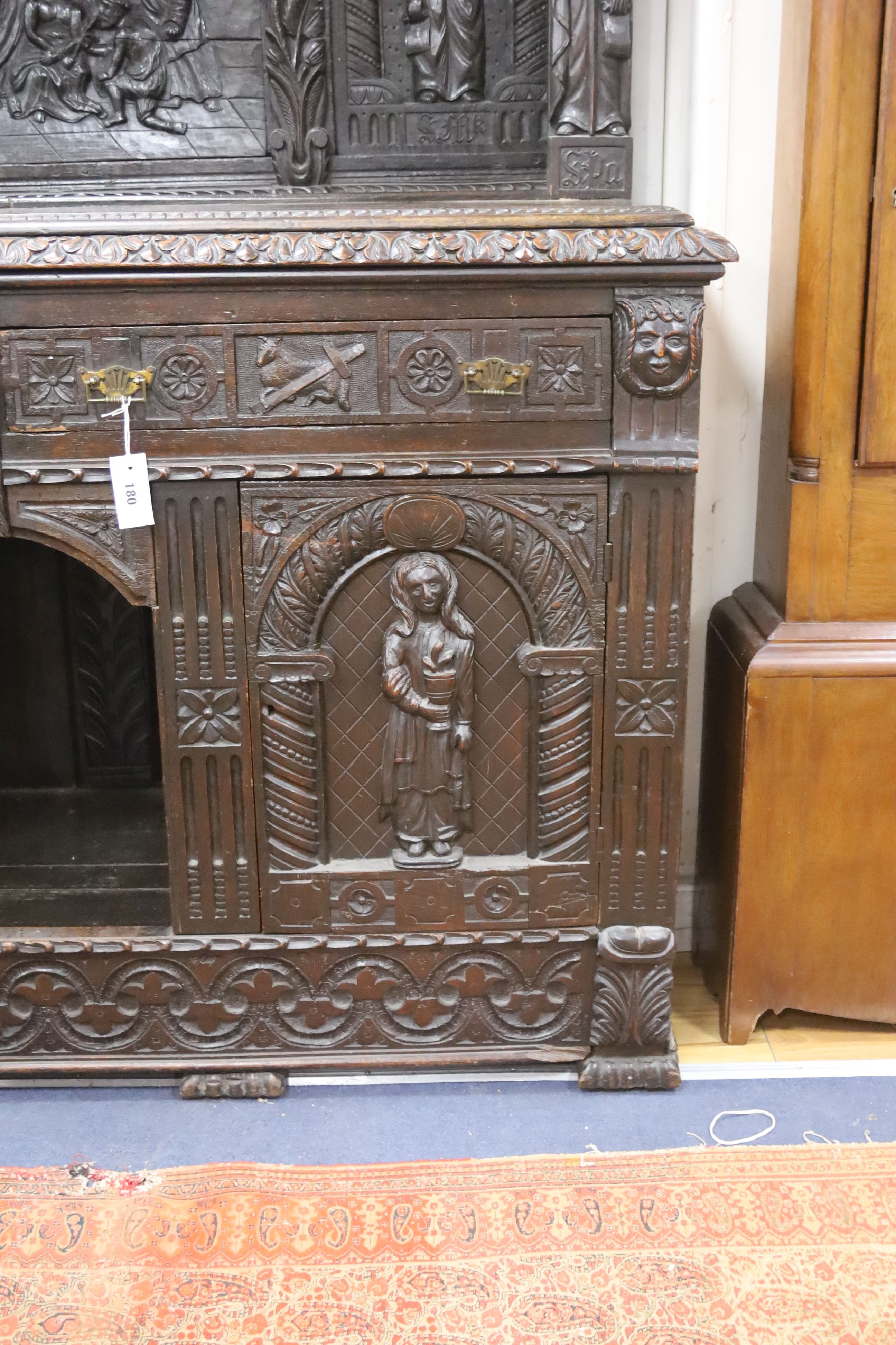 A late 19th century Flemish carved oak sideboard with raised panelled back, width 150, depth 60, height 215 cms.